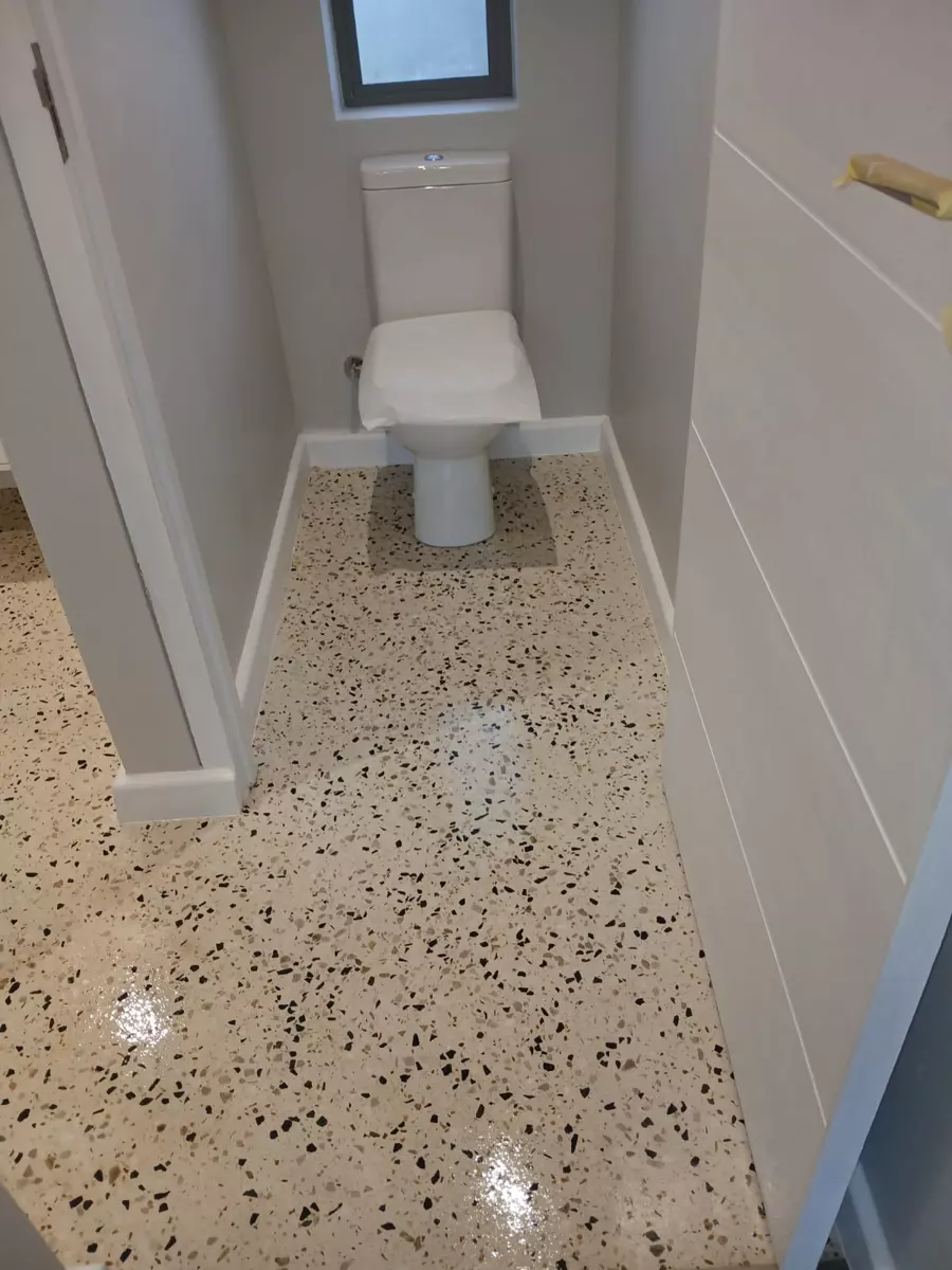 Renovated bathroom with speckled resin flooring