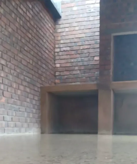 Brick wall with built-in outdoor braai structure
