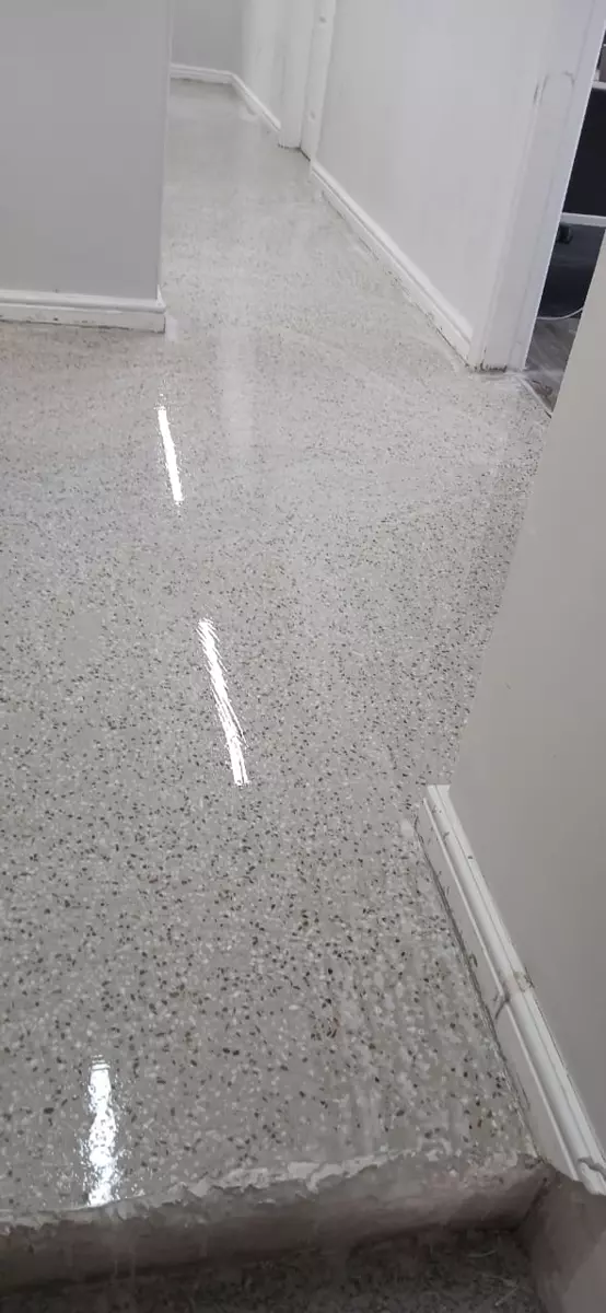 Glossy epoxy flake floor in a bright hallway