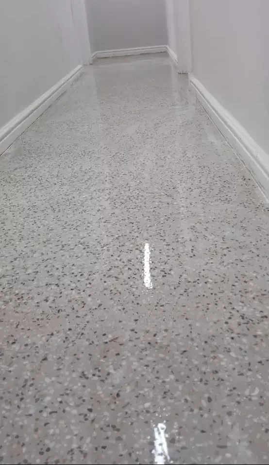 Reflective speckled epoxy flooring in a polished hallway